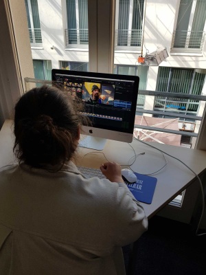 Junge Frau am Computer beim Videoschnitt